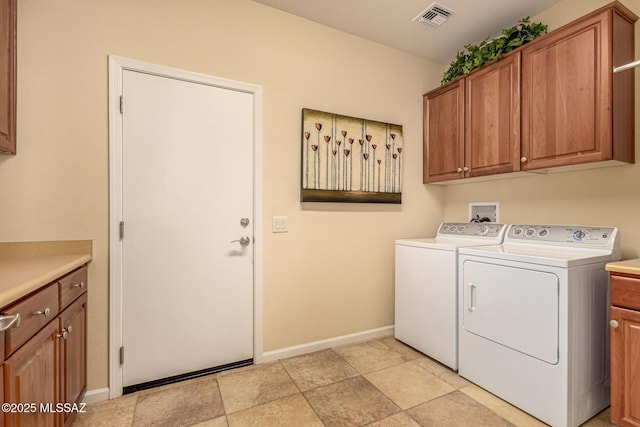 washroom with cabinets and washer and clothes dryer