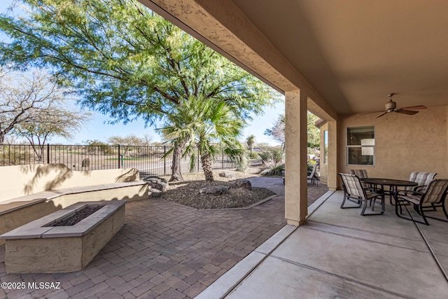 view of patio / terrace featuring ceiling fan and a fire pit