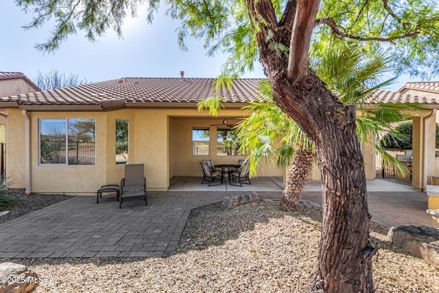 60782 E Arroyo Vista Dr, Oracle, AZ 85623 - back of property featuring stucco siding, a tile roof, and a patio