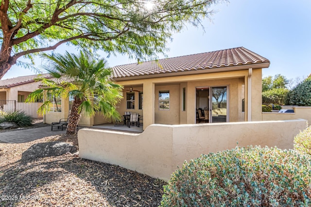 60782 E Arroyo Vista Dr, Oracle, AZ 85623 - rear view of house with stucco siding, a fenced front yard, and a tiled roof