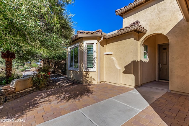 60782 E Arroyo Vista Dr, Oracle, AZ 85623 - doorway to property with a patio, stucco siding, and a tiled roof