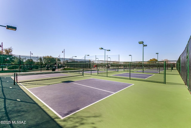 view of tennis court with basketball hoop