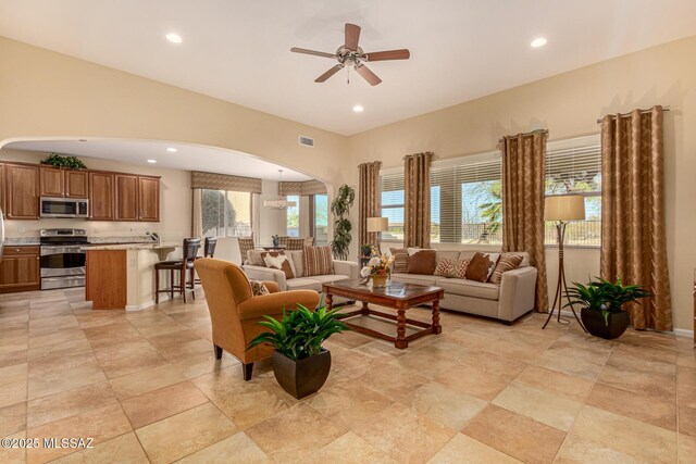 60782 E Arroyo Vista Dr, Oracle, AZ 85623 - living room featuring arched walkways, recessed lighting, visible vents, and ceiling fan