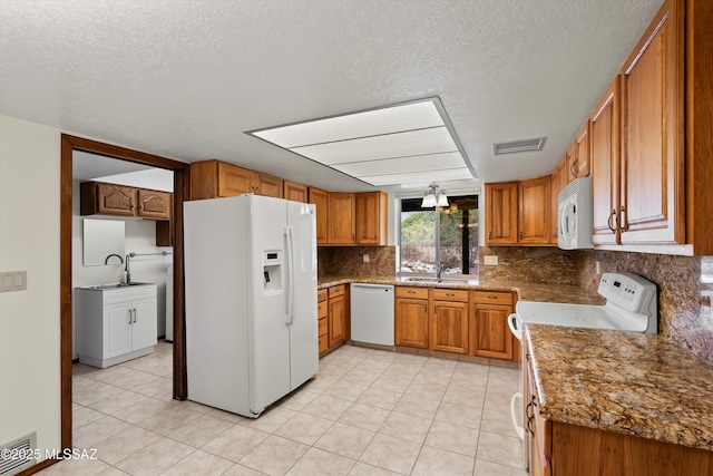 kitchen featuring sink, white appliances, tasteful backsplash, and light tile patterned flooring