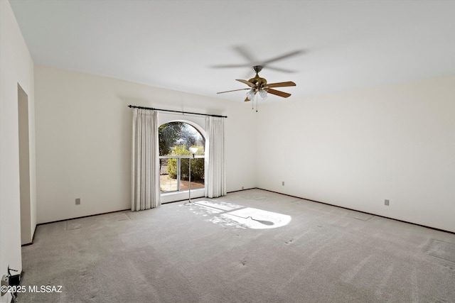 carpeted spare room featuring ceiling fan