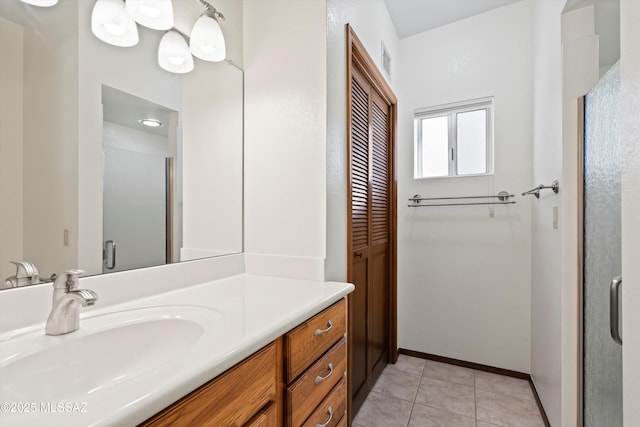 bathroom with vanity, walk in shower, and tile patterned floors