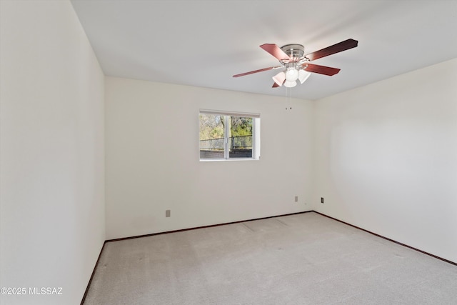 empty room featuring light colored carpet and ceiling fan