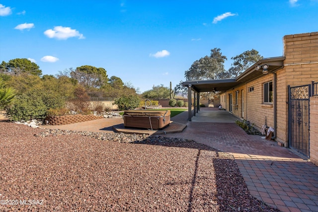 view of yard featuring a patio and a hot tub