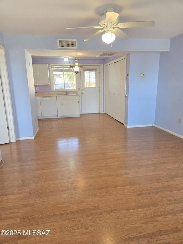 484 S La Canada Dr Unit B, Green Valley, AZ 85614 - unfurnished living room with sink, ceiling fan, and light wood-type flooring