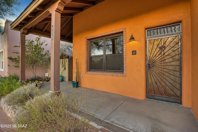 view of exterior entry featuring a patio