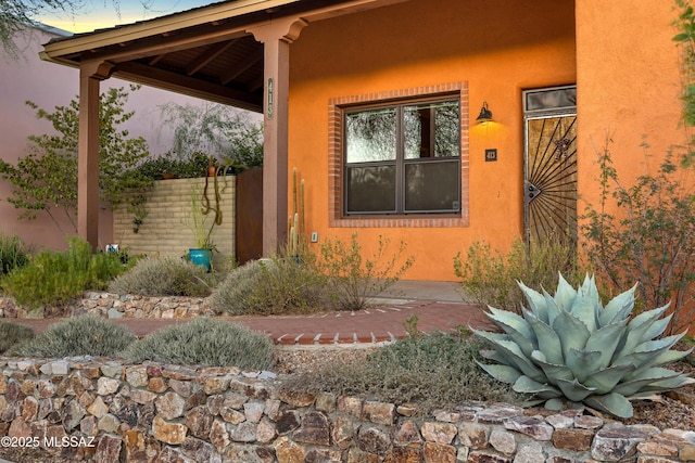 view of exterior entry at dusk