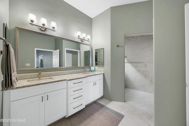 bathroom with a shower and vanity