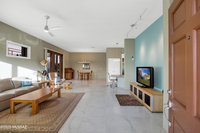 living room featuring ceiling fan and rail lighting