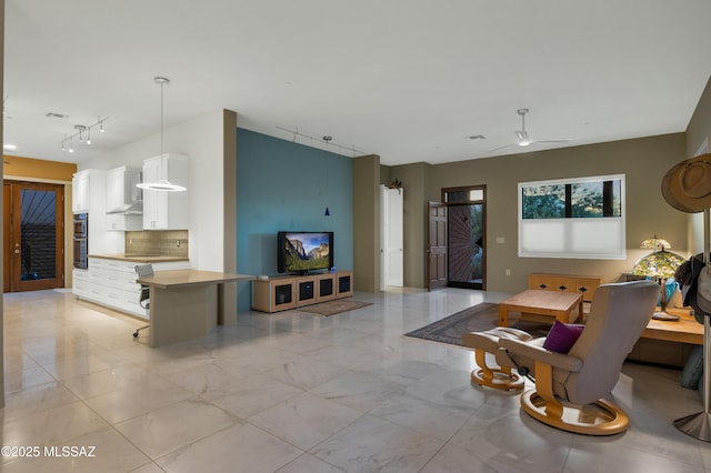 living room with track lighting and ceiling fan