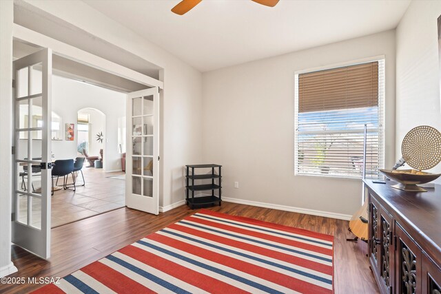 bedroom featuring ceiling fan, dark hardwood / wood-style flooring, access to outside, and vaulted ceiling