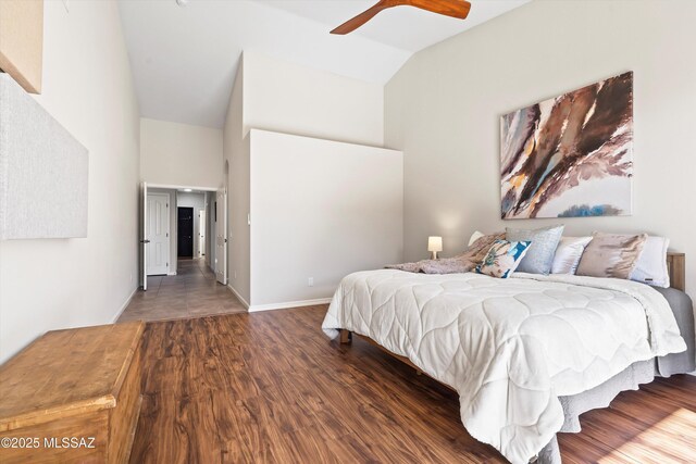 bedroom featuring ceiling fan, access to exterior, wood-type flooring, and lofted ceiling