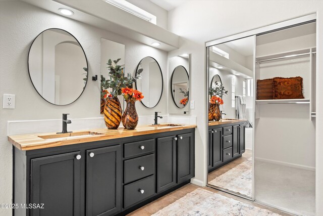 bathroom with tiled shower and tile patterned flooring