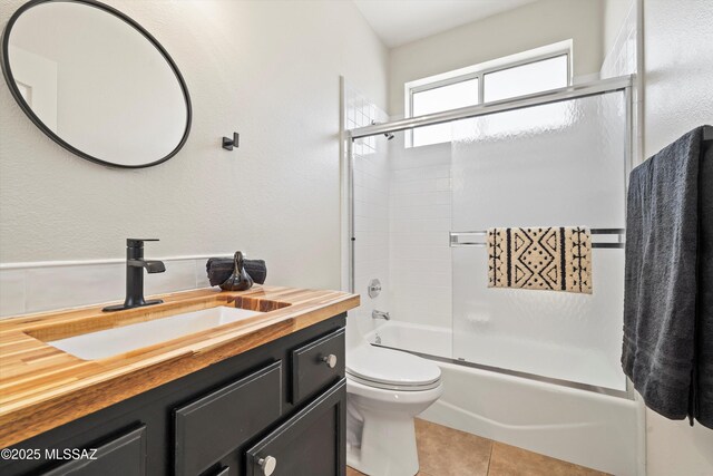 washroom with light tile patterned floors, cabinets, and washer and clothes dryer