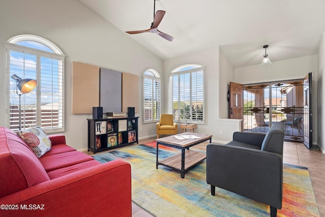 living room featuring ceiling fan, high vaulted ceiling, and light tile patterned flooring