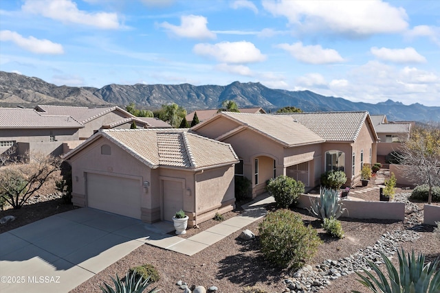 view of front of property with a mountain view and a garage