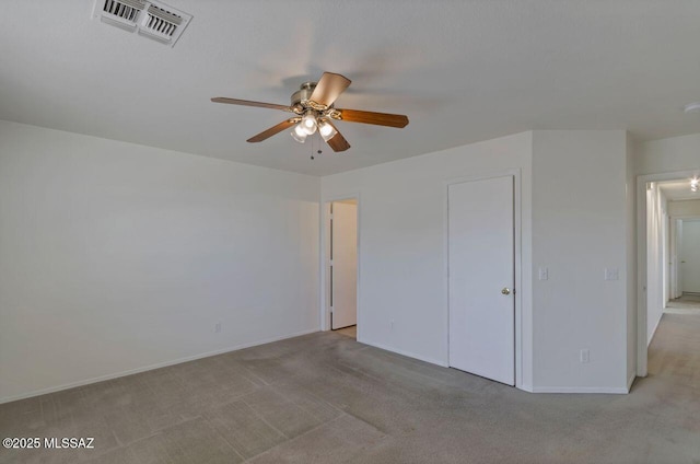 unfurnished bedroom featuring ceiling fan, a closet, and light carpet