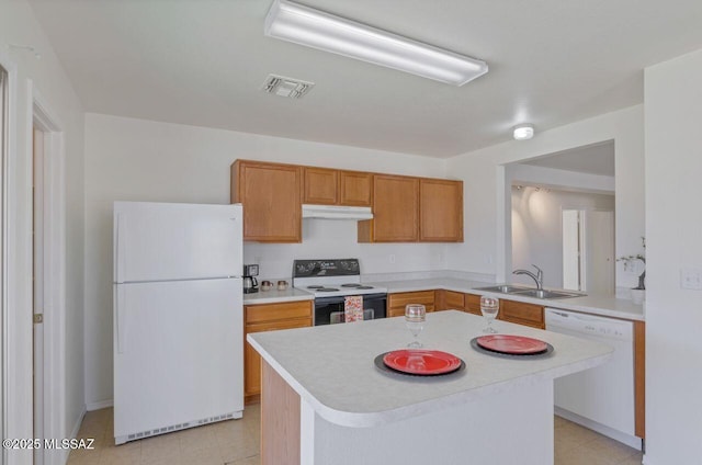 kitchen featuring sink, white appliances, kitchen peninsula, and a kitchen island