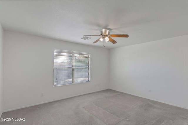 carpeted empty room featuring ceiling fan