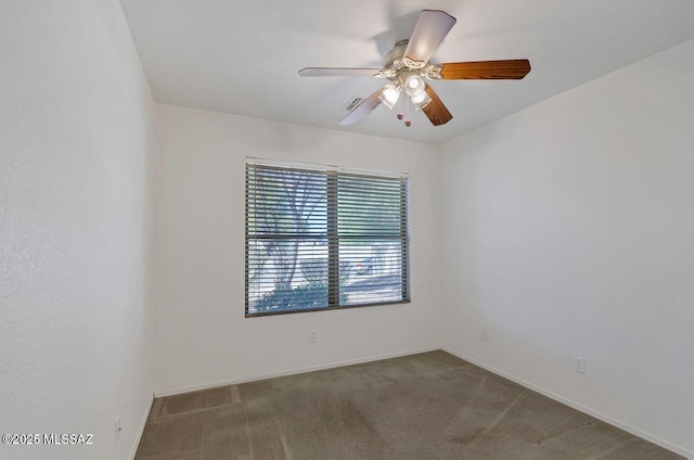 empty room with ceiling fan and carpet flooring