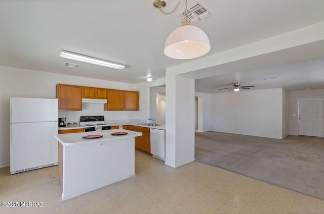 kitchen with ceiling fan, a center island, decorative light fixtures, white appliances, and sink