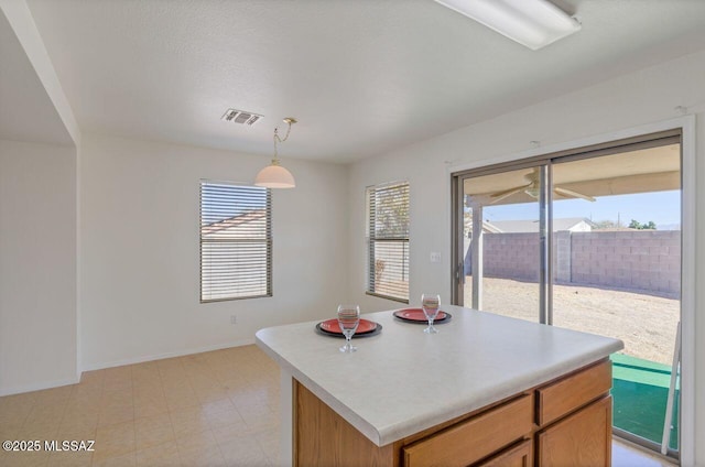 kitchen with decorative light fixtures and a kitchen island