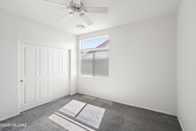 unfurnished bedroom featuring visible vents, baseboards, carpet, a closet, and a ceiling fan