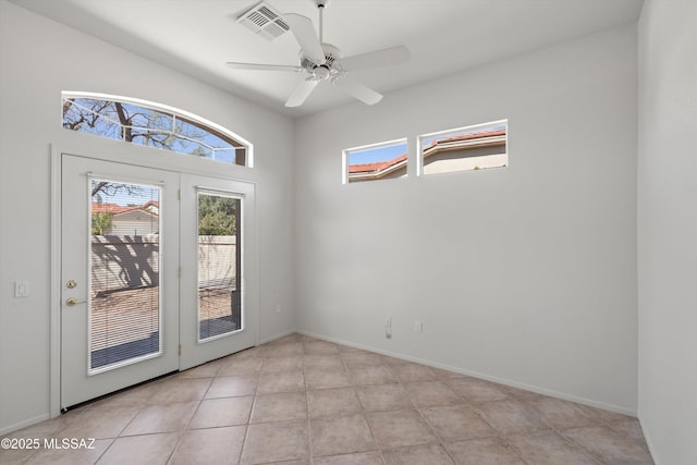 spare room with visible vents, baseboards, light tile patterned flooring, and a ceiling fan