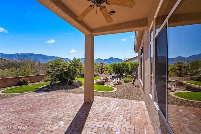 view of patio / terrace featuring a mountain view and ceiling fan