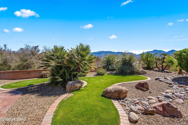 view of yard with a mountain view and fence
