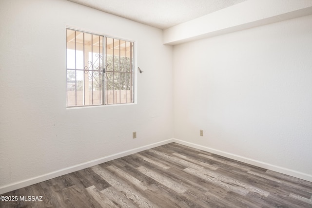 unfurnished room featuring dark hardwood / wood-style floors