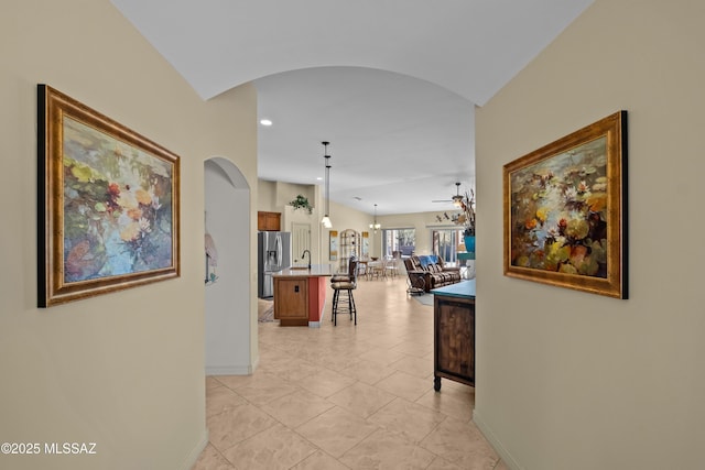 3534 E Sweet Grass Trl, Sahuarita, AZ 85629 - hall featuring arched walkways, baseboards, recessed lighting, and light tile patterned flooring