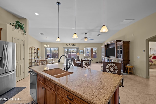 3534 E Sweet Grass Trl, Sahuarita, AZ 85629 - kitchen with appliances with stainless steel finishes, a sink, open floor plan, arched walkways, and ceiling fan