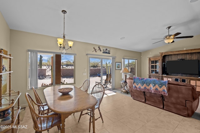 dining space featuring vaulted ceiling, ceiling fan with notable chandelier, and light tile patterned floors