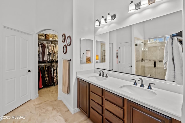 3534 E Sweet Grass Trl, Sahuarita, AZ 85629 - full bathroom featuring a shower stall, double vanity, a spacious closet, and a high ceiling