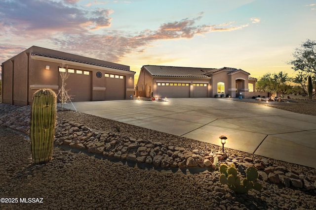 3534 E Sweet Grass Trl, Sahuarita, AZ 85629 - view of front of property featuring driveway, an attached garage, stucco siding, and a tiled roof