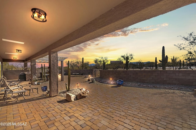 patio terrace at dusk with a pergola