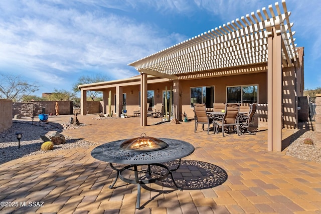 view of patio with a fire pit and a pergola