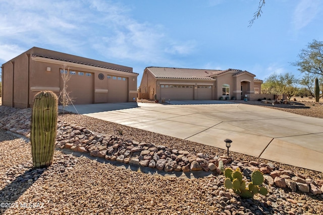 3534 E Sweet Grass Trl, Sahuarita, AZ 85629 - view of front of property featuring concrete driveway, stucco siding, a garage, and a tile roof