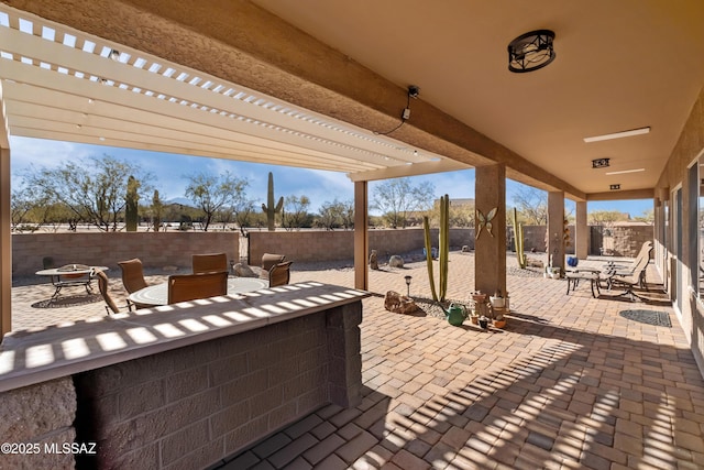 view of patio featuring a fire pit and a pergola