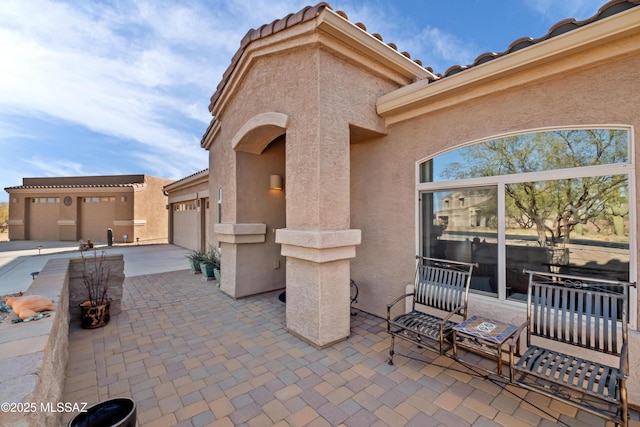 view of patio / terrace featuring a garage