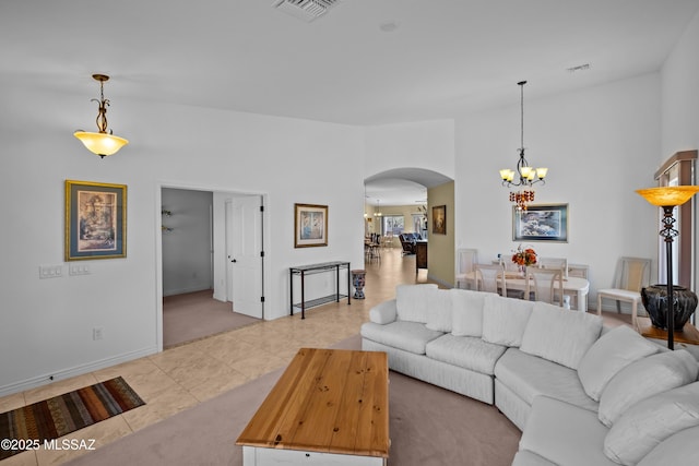 living room featuring light tile patterned floors and a notable chandelier