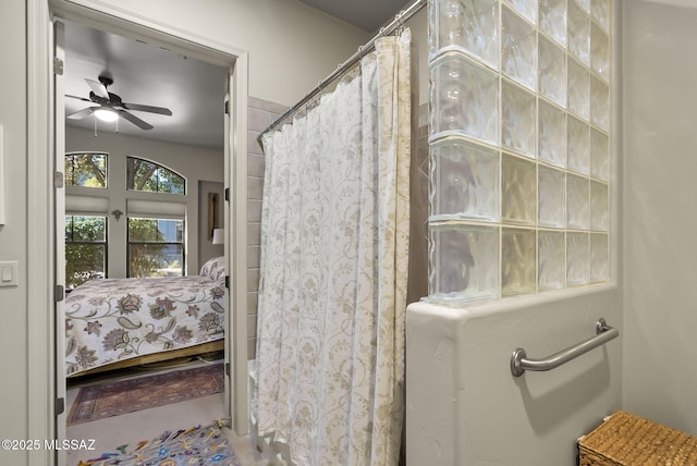 bathroom with ceiling fan and a shower with shower curtain