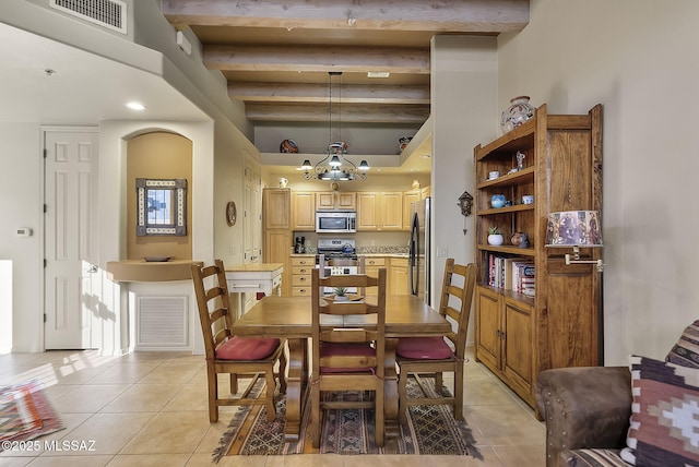 tiled dining area with a high ceiling, a notable chandelier, and beam ceiling