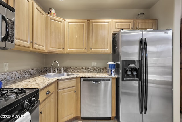 kitchen with stainless steel appliances, sink, and light brown cabinets