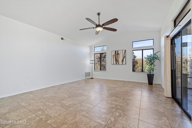 tiled empty room with high vaulted ceiling and ceiling fan